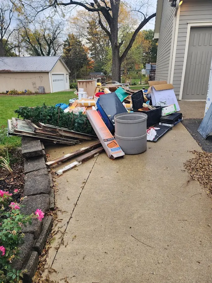 Dumpster being loaded with debris for 12 Yard Dumpster Rental in Fresno